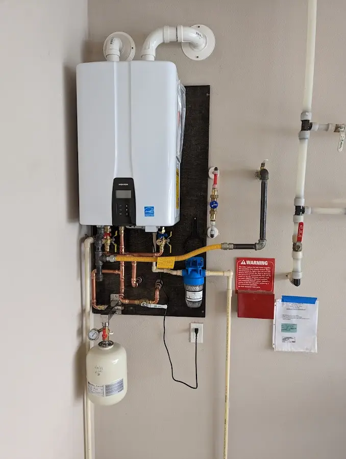 Professional plumber installing copper piping in a Southaven home